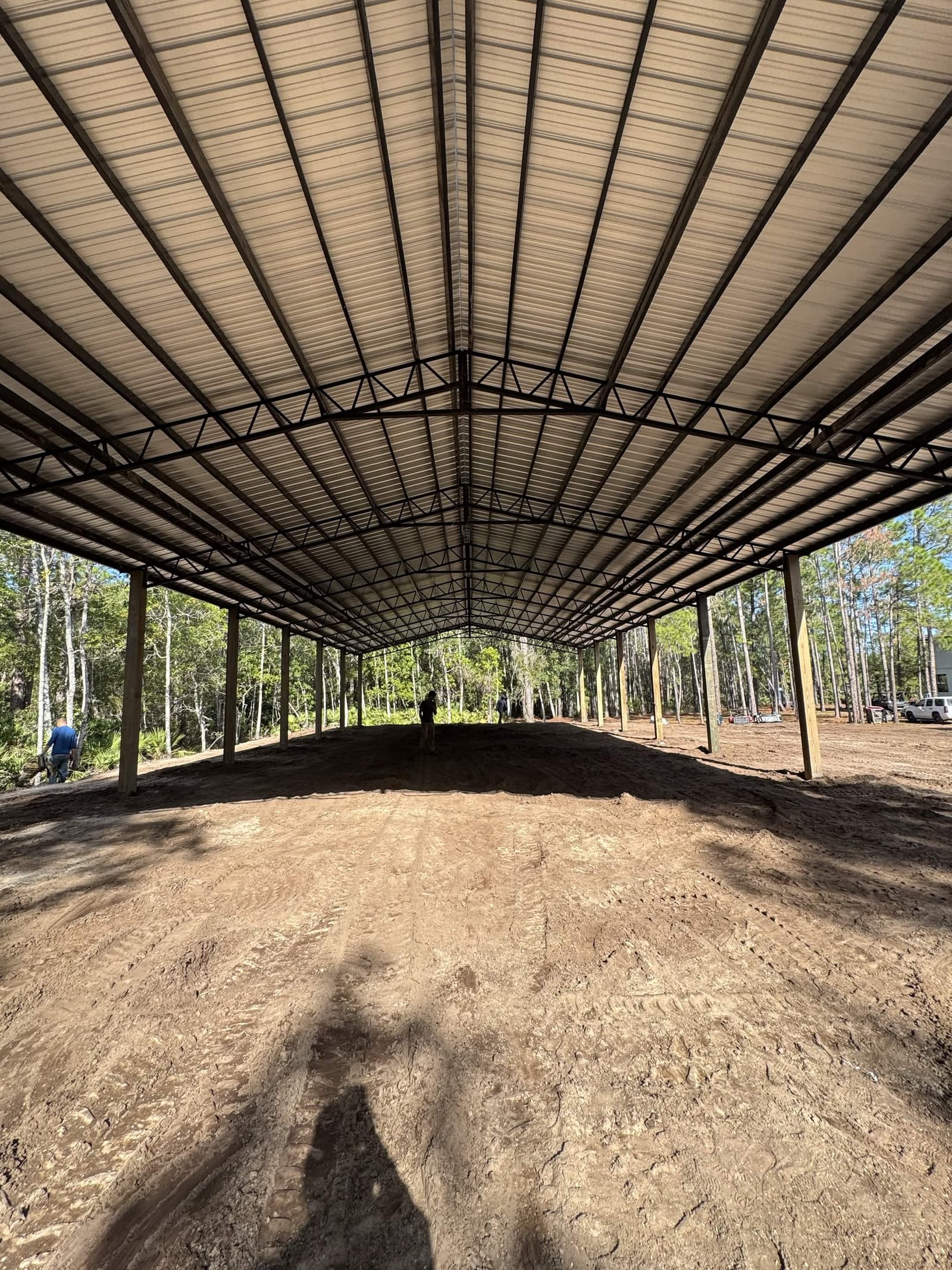 Interior of large covered arena with metal roof trusses